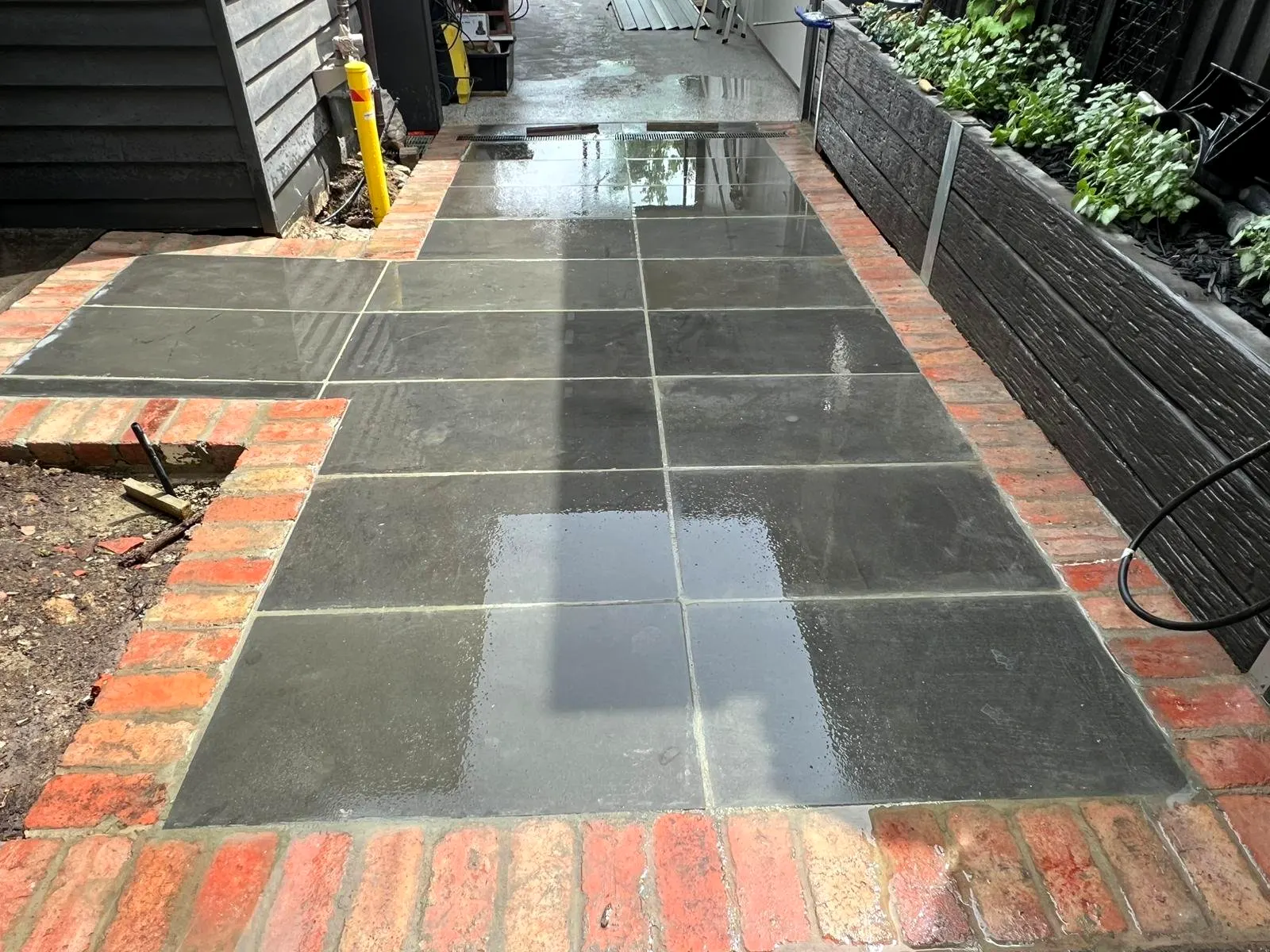 Bluestone paved side path with recycled red brick edging