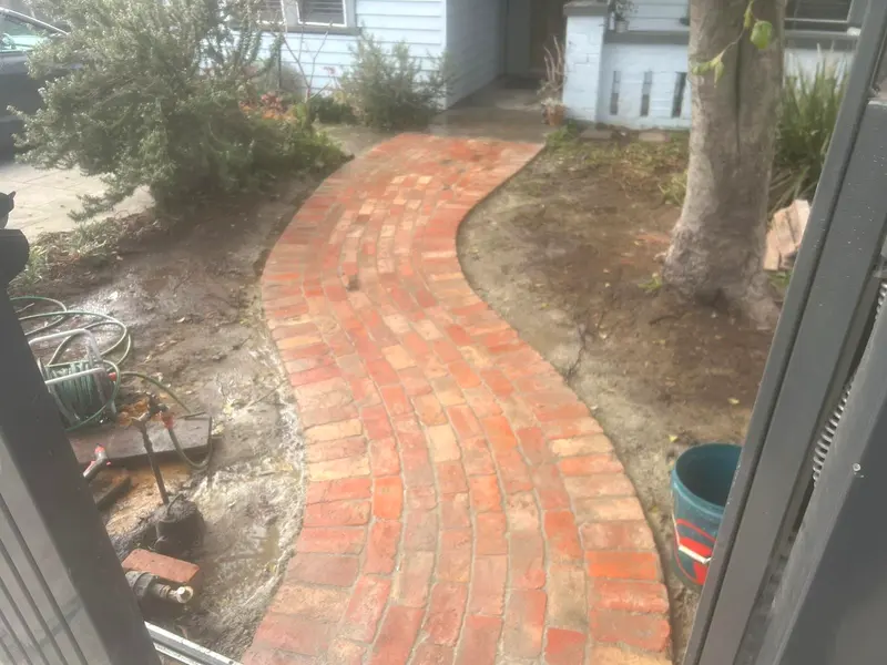 Curved red brick garden path